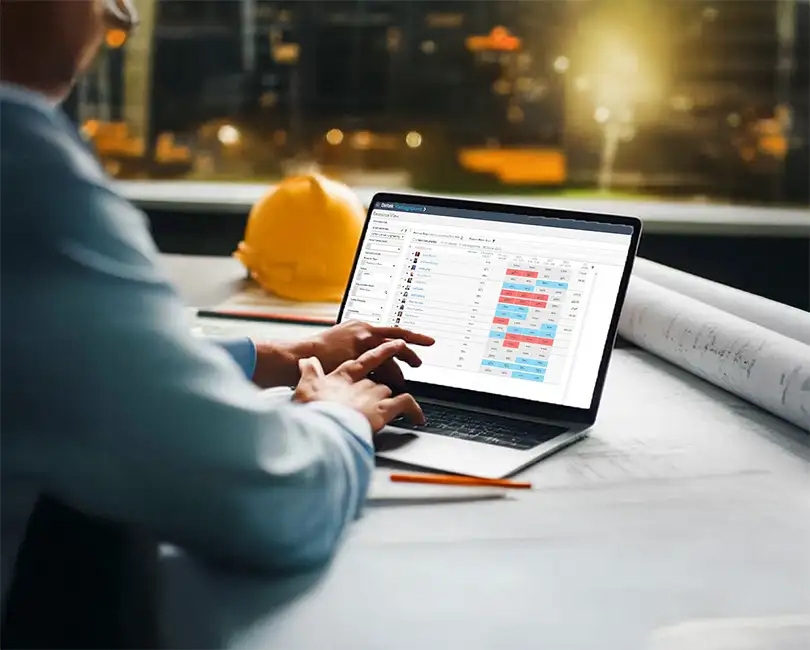 A person points at a laptop screen displaying a project management dashboard. Text overlay reads: "Deltek Vantagepoint: Master Resource Planning & Project Management for Project-Based Firms." By Michelle Whitaker.