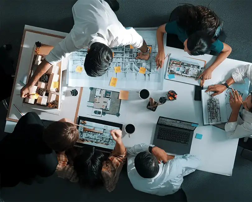 Two people review architectural blueprints and plans on a table with coffee cups and stationery. Text overlay reads: "ESOPs in AEC: 3 Essential Lessons for Leaders" by Brad Wilson, CMA, MBA. Stambaugh Ness logo appears at the bottom.