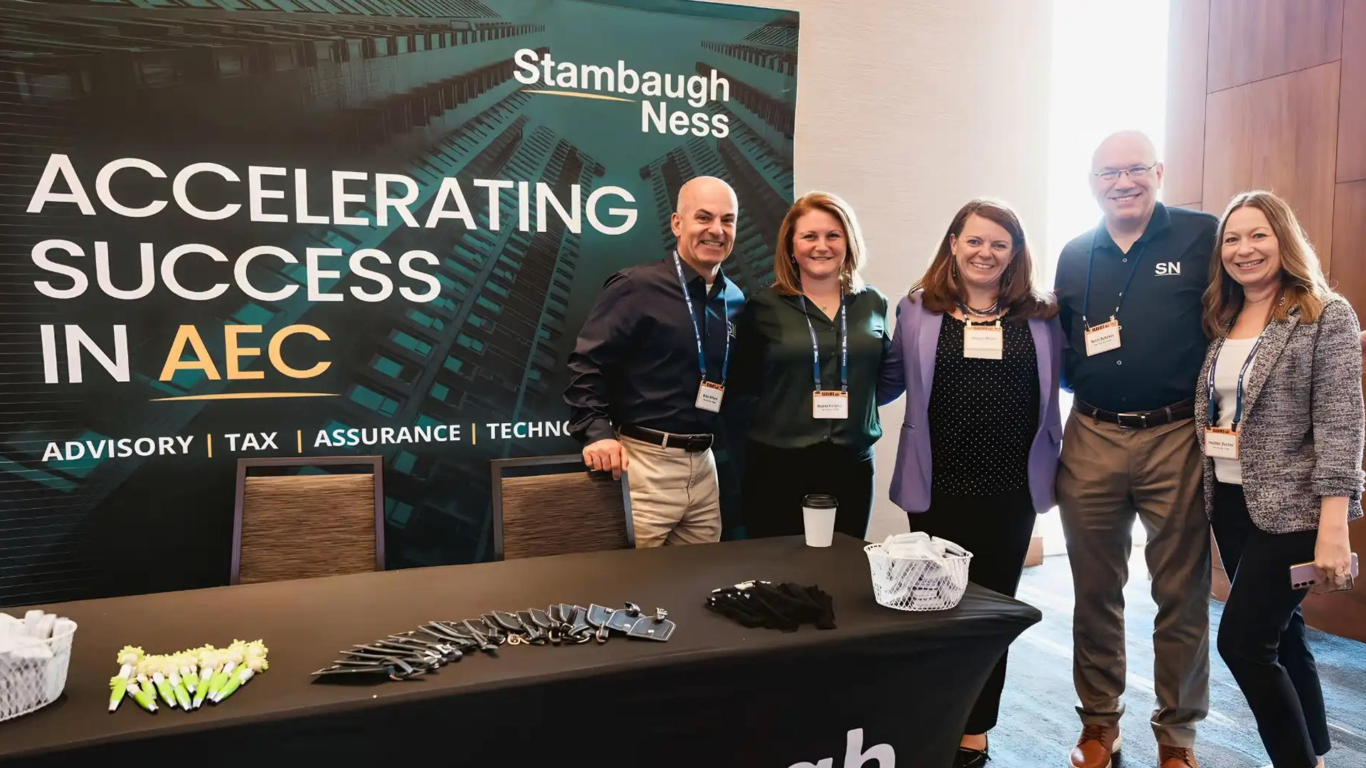 Stambaugh Ness team members standing in front of the Stambaugh Ness booth that proudly displays Accelerating Success in AEC L2R: Brad Wilson, Alyson Field,an, Megan Miller, Scott Butcher, Heather Zecher