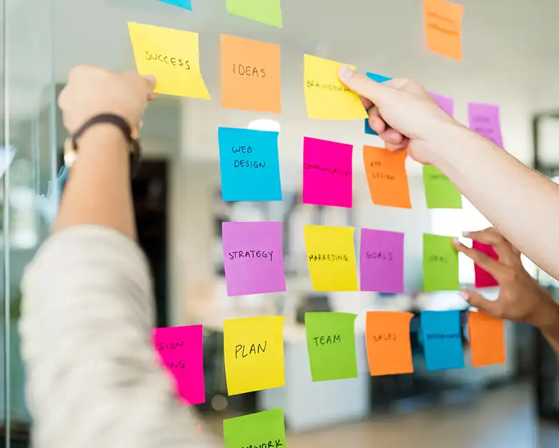 Stambaugh Ness blog cover featuring a collaborative AEC strategic planning workshop with sticky notes on glass, titled "10 Strategic Planning Pitfalls Holding AEC Firms Back (And How to Fix Them)" by Scott D. Butcher.