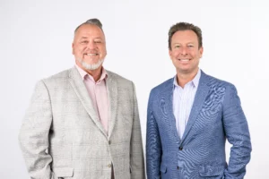 Steven L. Hake, President and CEO of Stambaugh Ness, and Chad Clinehens, President and CEO of Zweig Group, standing side-by-side.