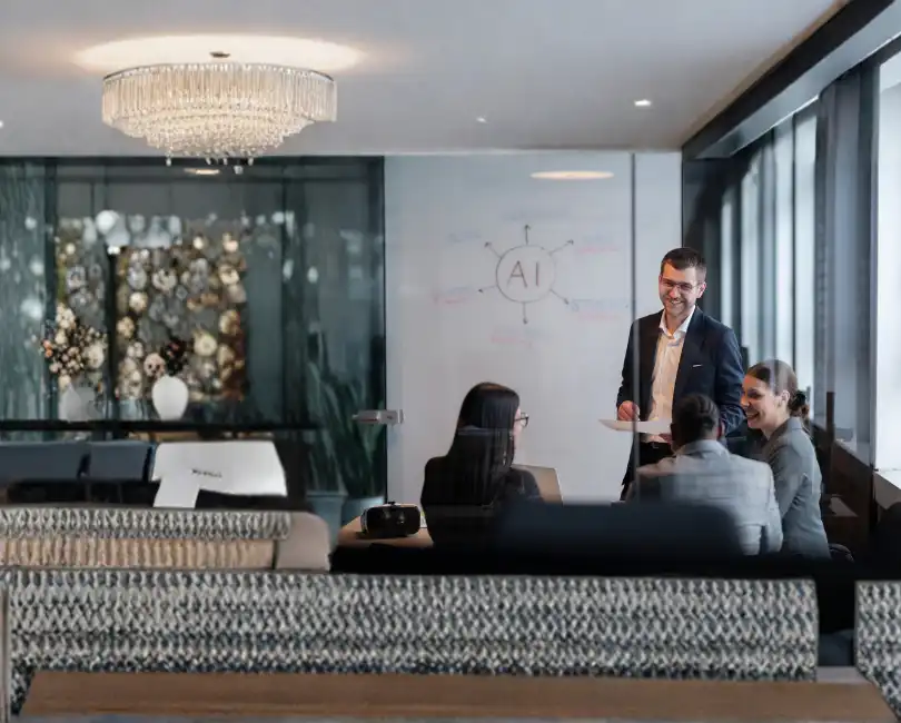 AEC firm leadership team meeting in glass conference room discussing AI strategy and operational planning on a whiteboard.